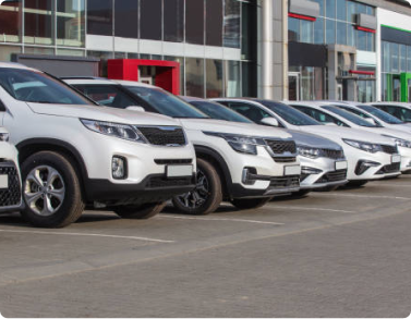 New cars parked outside automotive dealers