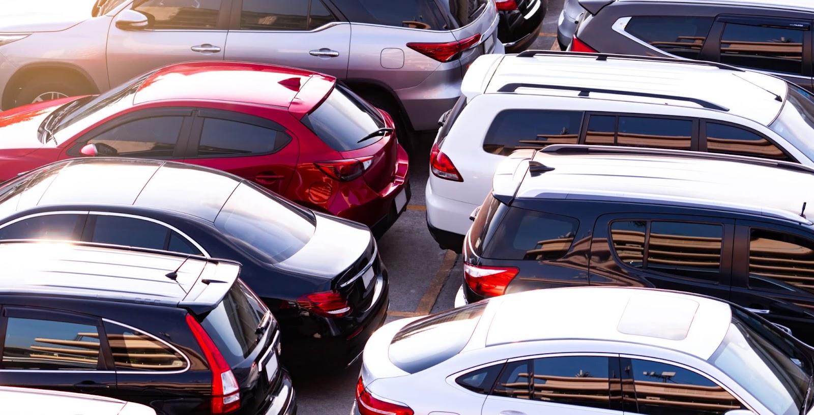Rows of new cars parked at a dealership lot. Optimizing dealership inventory turnover can help ensure a fresh selection of vehicles to meet customer demand.